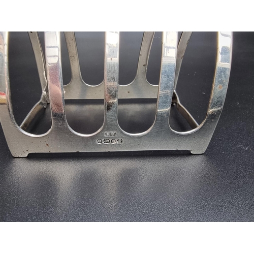 305 - A pair of silver five bar toast racks, by Viners, Sheffield 1935, 7.5cm long; together with another ... 