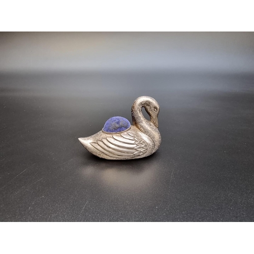 307 - A Chinese white metal swan pin cushion, stamped marks to base, 6.5cm long.