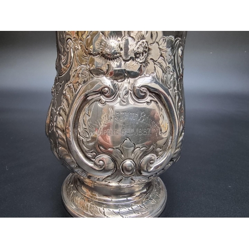 314 - A George III silver baluster pint mug, having later embossed decoration, by Peter & Anne Bateman... 