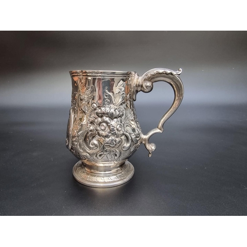 314 - A George III silver baluster pint mug, having later embossed decoration, by Peter & Anne Bateman... 