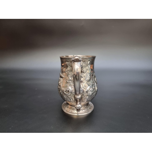 314 - A George III silver baluster pint mug, having later embossed decoration, by Peter & Anne Bateman... 