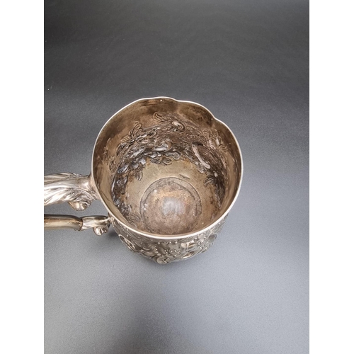 314 - A George III silver baluster pint mug, having later embossed decoration, by Peter & Anne Bateman... 