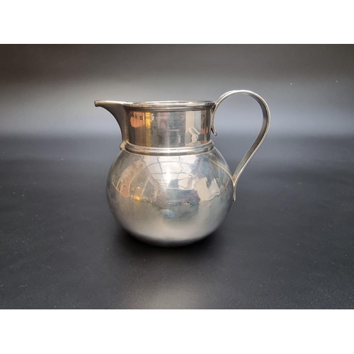 322 - A silver milk jug by Vander & Hedges, London 1918, engraved crest, 11cm high, 347g.... 