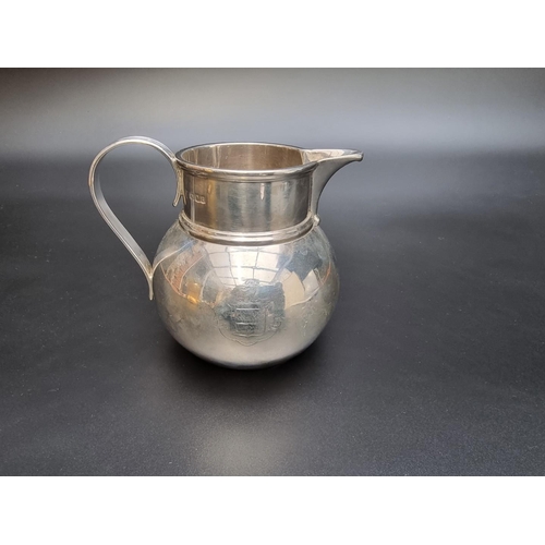 322 - A silver milk jug by Vander & Hedges, London 1918, engraved crest, 11cm high, 347g.... 