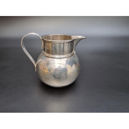 322 - A silver milk jug by Vander & Hedges, London 1918, engraved crest, 11cm high, 347g.... 