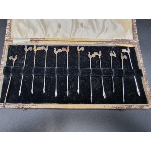 374 - A cased set of twelve silver cocktail sticks, the terminals decorated gilt cockerel, by Adolph Scott... 