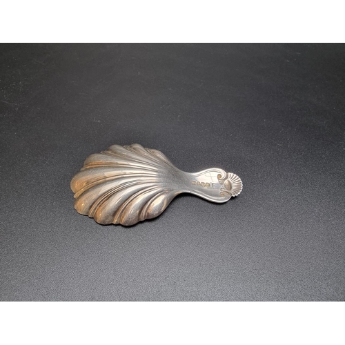 406 - A Victorian silver shell caddy spoon, by Yapp & Woodward, Birmingham 1846, 16.4g.... 