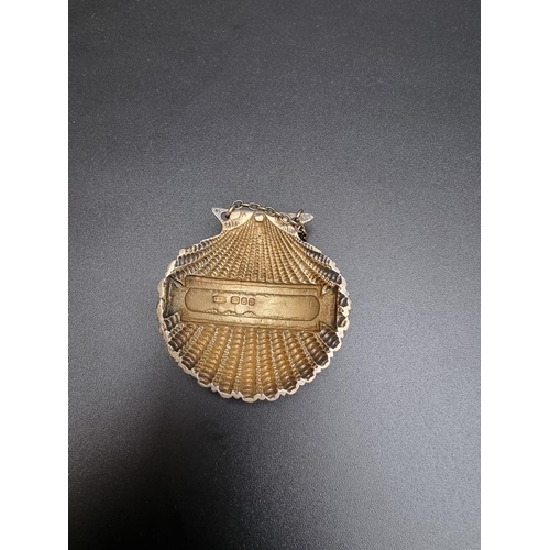 416 - A silver scallop shell 'Sherry' label, by F S Ltd, London 1960, 51mm wide, 31g.