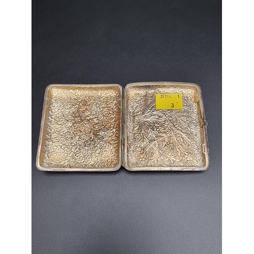 423 - An Anglo Indian white metal cigarette case, having chased floral decoration, 87mm.