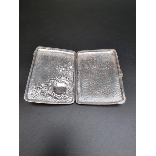 425 - A hammered and embossed silver cigarette case by Colen Hewer Cheshire, Chester, 10.4cm, 78g.... 