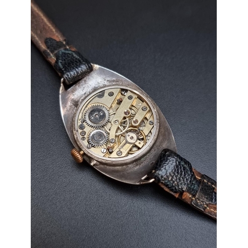 482 - A silver wristwatch, import mark London 1912, 27mm wide, on leather strap.