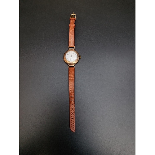 519 - A 9ct gold manual wind ladies wristwatch, on brown leather strap.