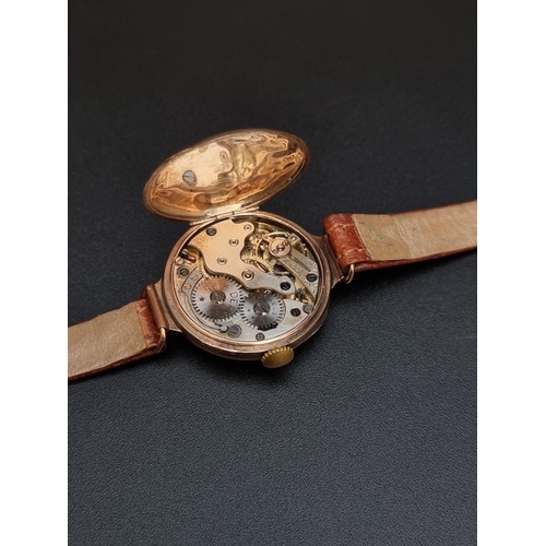 519 - A 9ct gold manual wind ladies wristwatch, on brown leather strap.