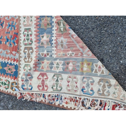 1006 - A Kelim carpet, having star and geometric design, 192 x 117cm. 