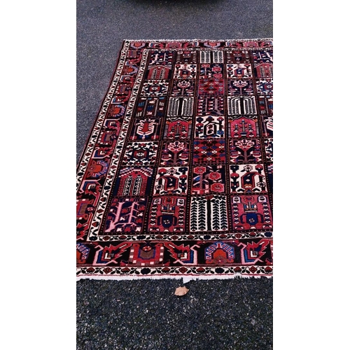 1015 - A Persian carpet, having gul design to central field, with tree decoration, floral borders, 300 x 20... 