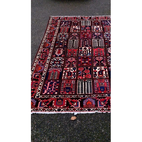 1015 - A Persian carpet, having gul design to central field, with tree decoration, floral borders, 300 x 20... 