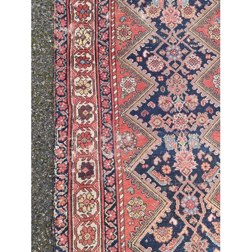 1016 - A Persian runner, having central diamond with floral and geometric design, with floral borders on a ... 