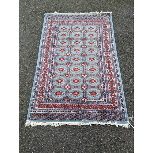 1018 - A Bokhara rug, having repeated design to central field, on a blue ground, 188 x 119cm. ... 