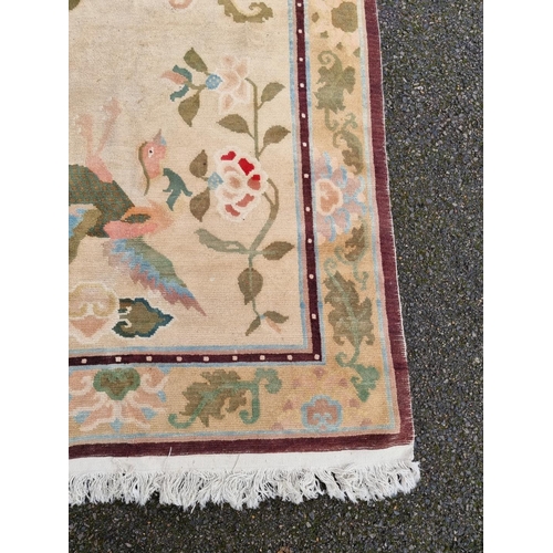 1022 - An Oriental rug, with floral decoration and birds, 190 x 121cm.