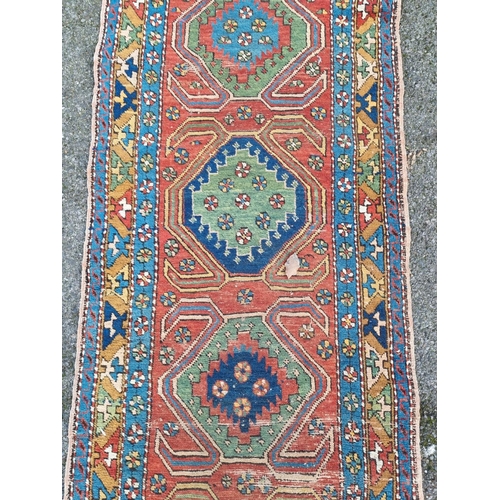 1023 - A Persian runner, having five central medallions, with geometric borders, 270 x 84cm.... 