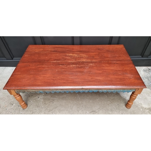 1034 - A large Eastern stained wood rectangular low occasional table, with blue painted and carved frieze, ... 