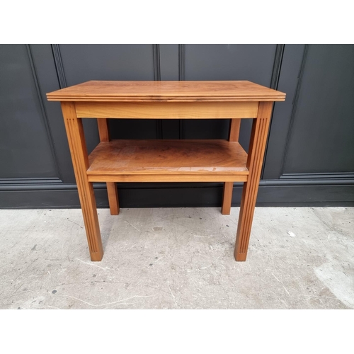 1040 - A walnut two tier occasional table, 76.5cm wide. 