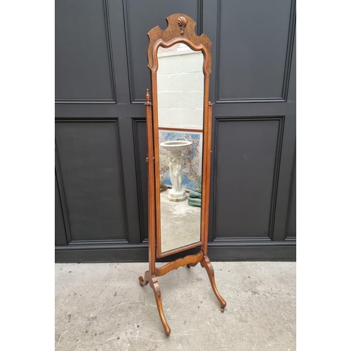 1043 - A 1930s walnut cheval mirror, 172cm high x 40.5cm wide.