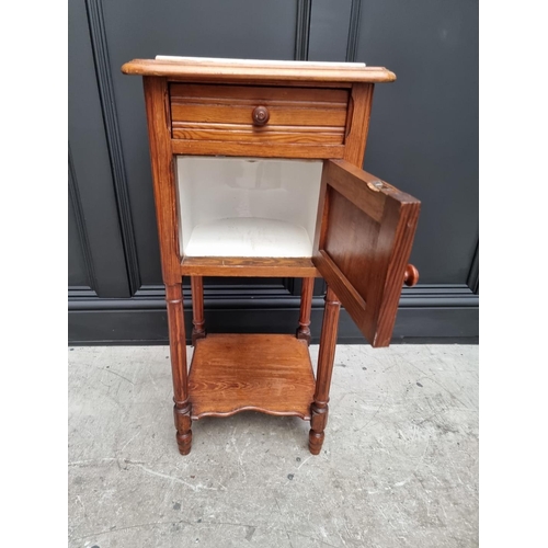 1045 - A late Victorian pitch pine and marble top pot cupboard, 39cm wide. 