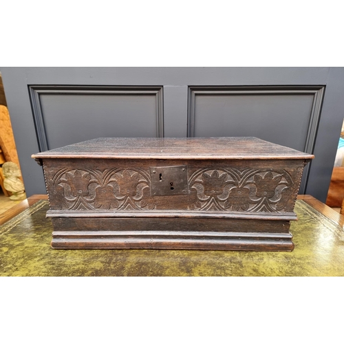 1049 - A late 17th century carved oak boarded bible box, with floral carved frieze and concealed apron draw... 