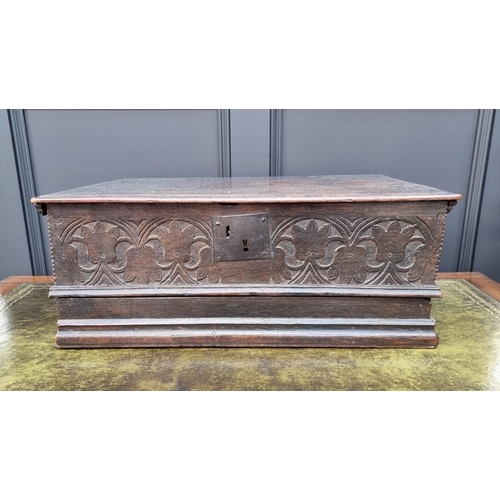 1049 - A late 17th century carved oak boarded bible box, with floral carved frieze and concealed apron draw... 