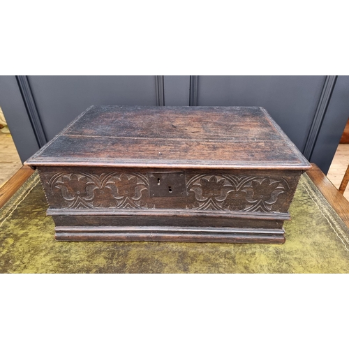 1049 - A late 17th century carved oak boarded bible box, with floral carved frieze and concealed apron draw... 