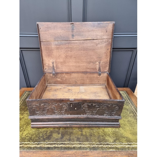 1049 - A late 17th century carved oak boarded bible box, with floral carved frieze and concealed apron draw... 