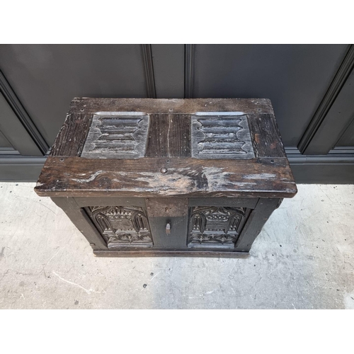 1054 - A small antique carved oak panelled coffer, possibly 16th century, with linenfold decoration to top ... 