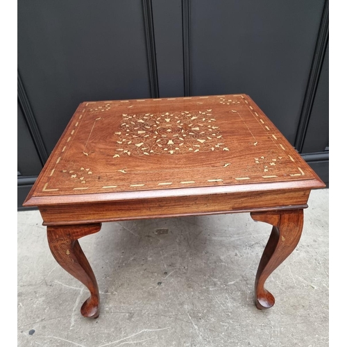 1058 - A hardwood and brass inlaid low occasional table, 58.5cm wide. 