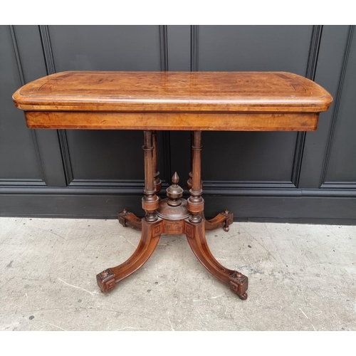 1061 - A Victorian walnut and inlaid card table, with swivel top, 92.5cm wide. 