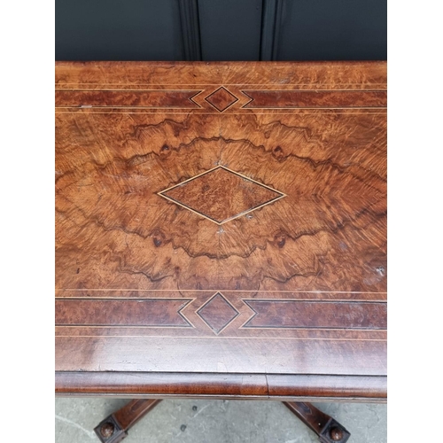 1061 - A Victorian walnut and inlaid card table, with swivel top, 92.5cm wide. 