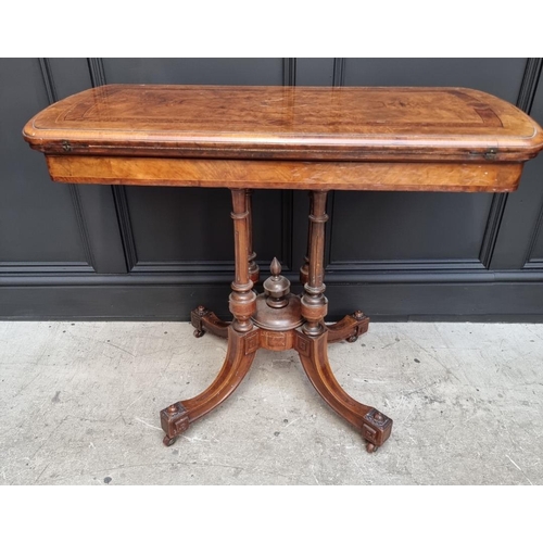 1061 - A Victorian walnut and inlaid card table, with swivel top, 92.5cm wide. 