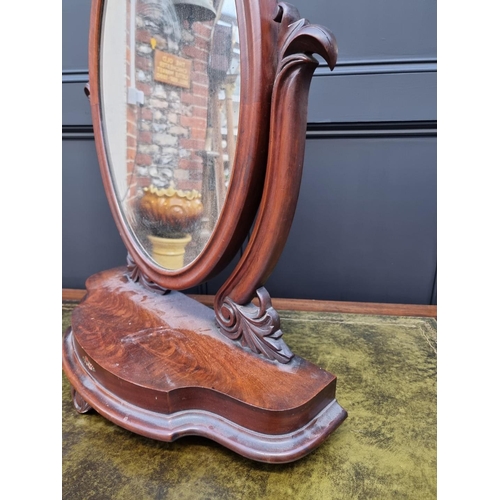 1062 - A Victorian mahogany toilet mirror, 66cm wide. 