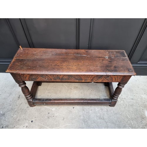 1064 - An antique oak long joint stool, 91.5cm long.