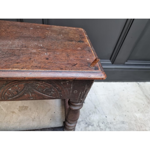 1064 - An antique oak long joint stool, 91.5cm long.