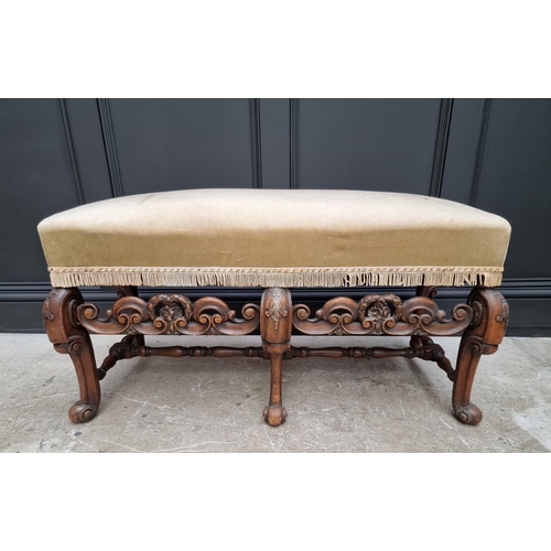 1067 - A William and Mary style carved walnut and upholstered long stool, 104cm wide.