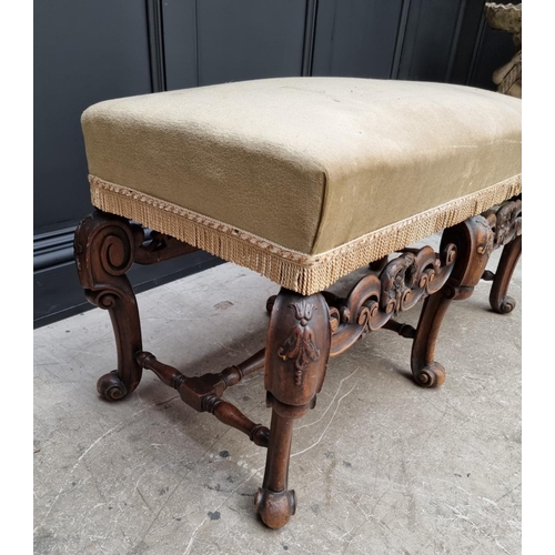 1067 - A William and Mary style carved walnut and upholstered long stool, 104cm wide.