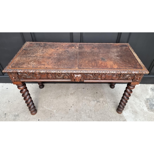 1068 - A late Victorian carved oak desk, with leather inset service above a pair of frieze drawers, 117cm w... 