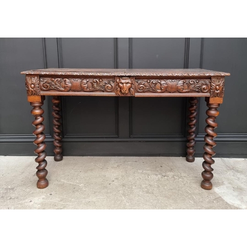 1068 - A late Victorian carved oak desk, with leather inset service above a pair of frieze drawers, 117cm w... 