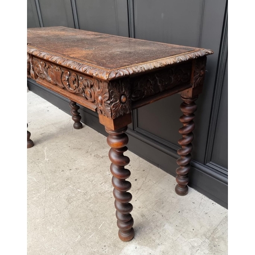 1068 - A late Victorian carved oak desk, with leather inset service above a pair of frieze drawers, 117cm w... 