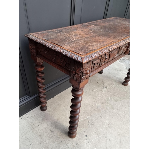 1068 - A late Victorian carved oak desk, with leather inset service above a pair of frieze drawers, 117cm w... 