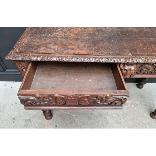 1068 - A late Victorian carved oak desk, with leather inset service above a pair of frieze drawers, 117cm w... 