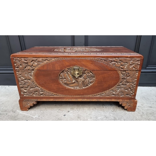 1071 - A Chinese carved camphor wood coffer, 83cm wide. 