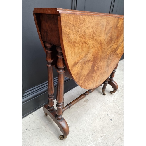 1072 - A Victorian figured walnut Sutherland table, 76cm wide.