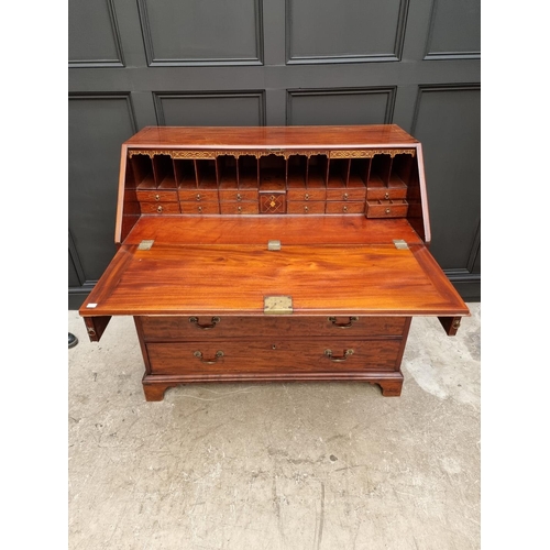 1083 - A George III mahogany bureau, the interior with inlaid drawers, 112cm wide. 